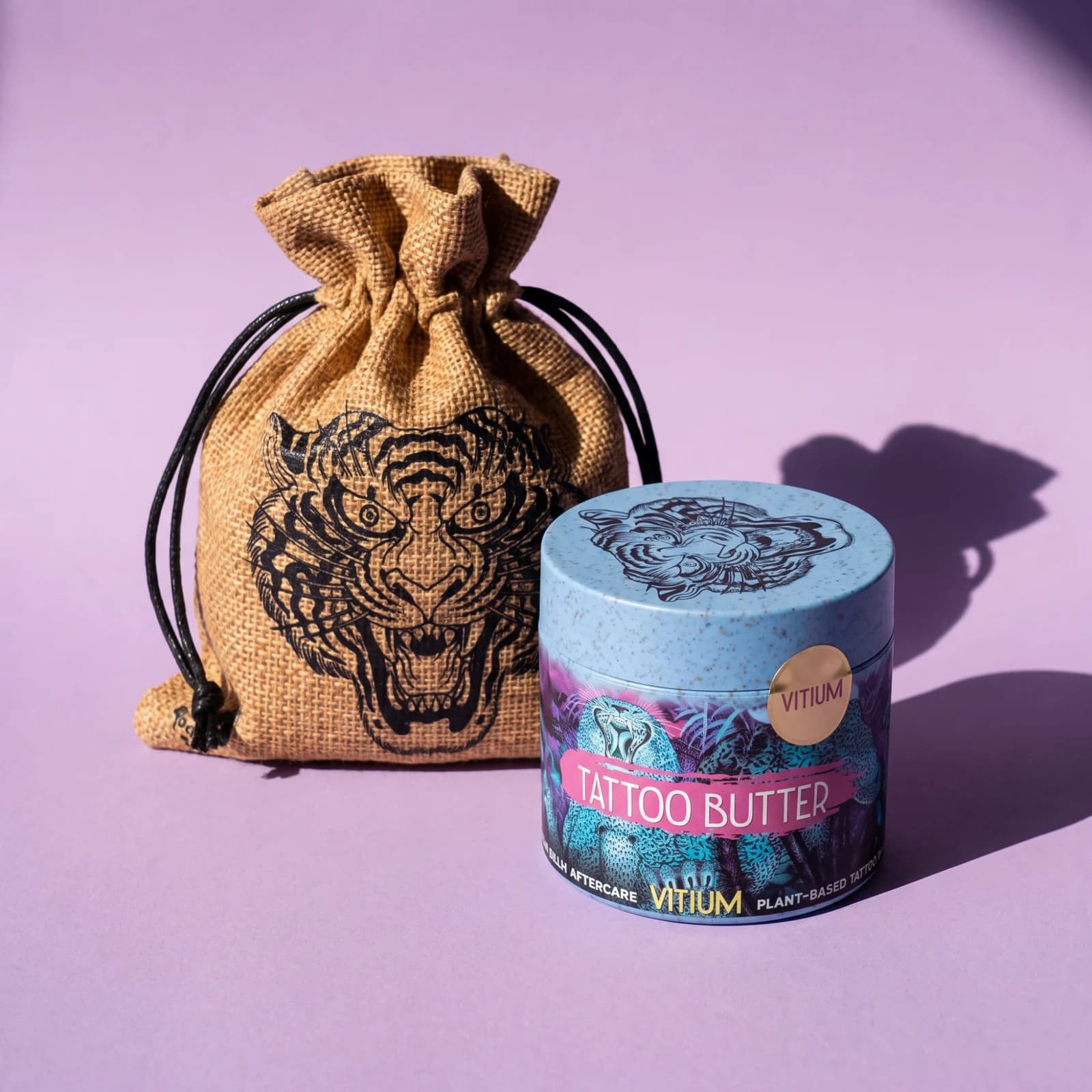 VITIUM Tattoo Butter jar in front of its tiger drawstring bag